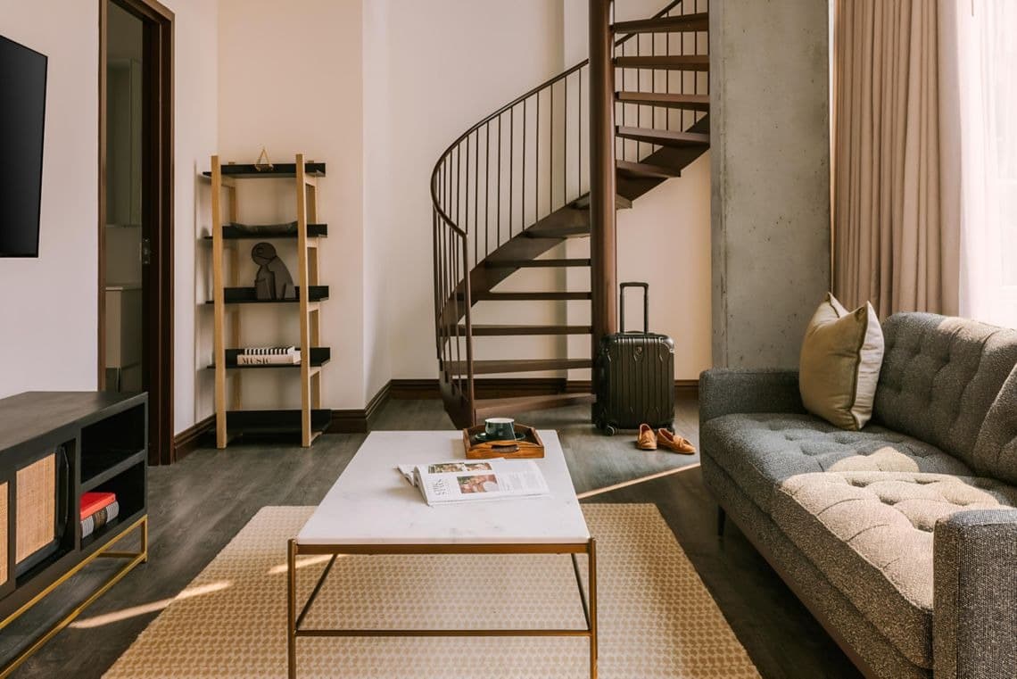 Spacious apartment living room with contemporary furnishings and heritage details at Nester Finn Brésoles