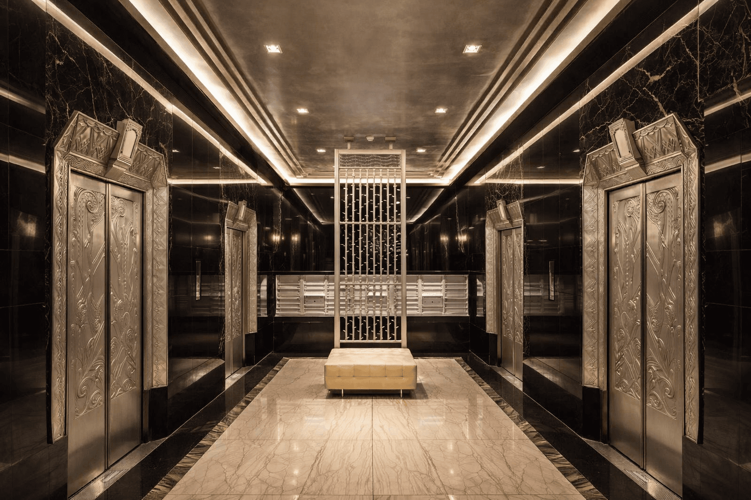 Art Deco marble lobby at One Platt Street after the 2011 conversion, with ornamental elevator doors and a central metal screen